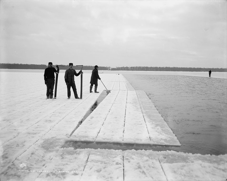 Men cutting blocks of ice on the lake